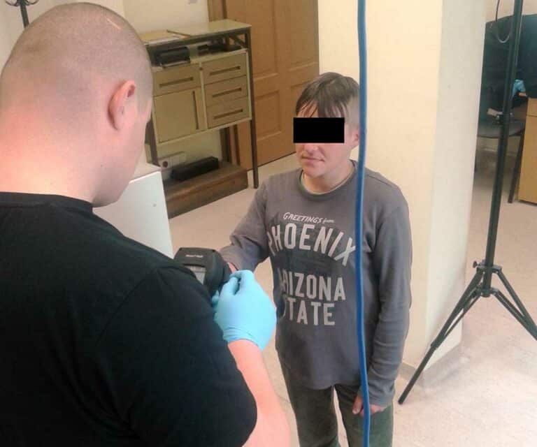 Mężczyzna podczas wykonywania zdjęcia w pomieszczeniu.