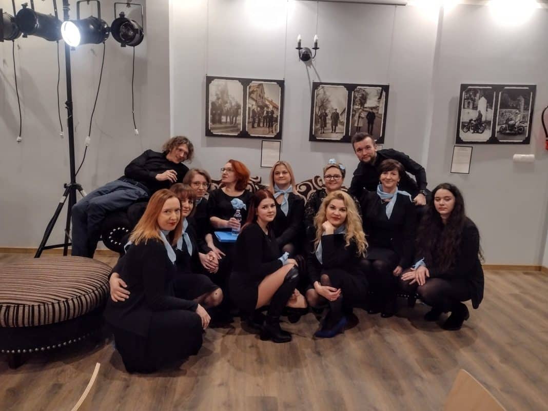 Grupa osób w studio muzycznym, promująca pasję śpiewania.