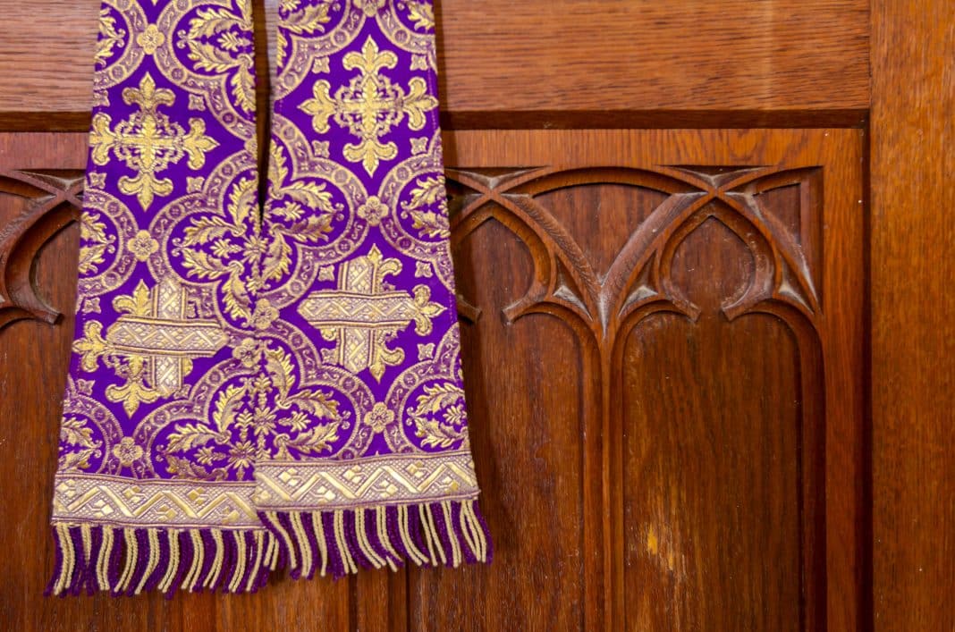 Purple priest stole used for confessions, vestment purple and gold as worn during confession and mass.