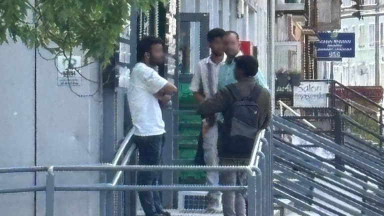 obcokrajowcy pod biurem poselskim