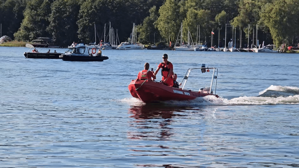 Wszyscy zaskoczeni. Akcja służb ratunkowych na Plaży Miejskiej. - 12 spadochroniarzy wpadło do jeziora Ukiel pełnego turystów. Służby ratunkowe w akcji