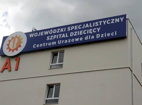 Widok na budynek szpitala dziecięcego z dużym oznaczeniem i nazwą placówki.