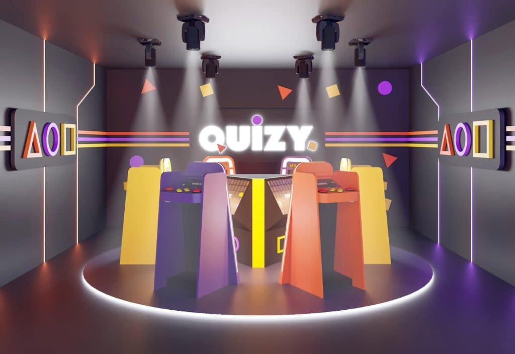 Wewnątrz nowoczesnego lokalu rozrywkowego z konsolami do gier i kolorowymi elementami dekoracyjnymi.