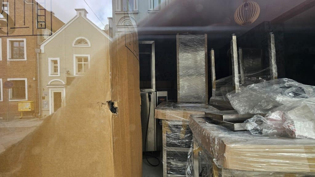 Widok zamkniętego lokalu gastronomicznego na olsztyńskiej Star&oacute;wce, widoczne opakowania i sprzęt kuchenny.