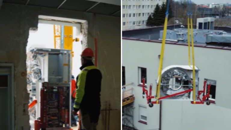 Pracownicy instalują nowoczesne urządzenie diagnostyczne przez wybite okno w szpitalu.