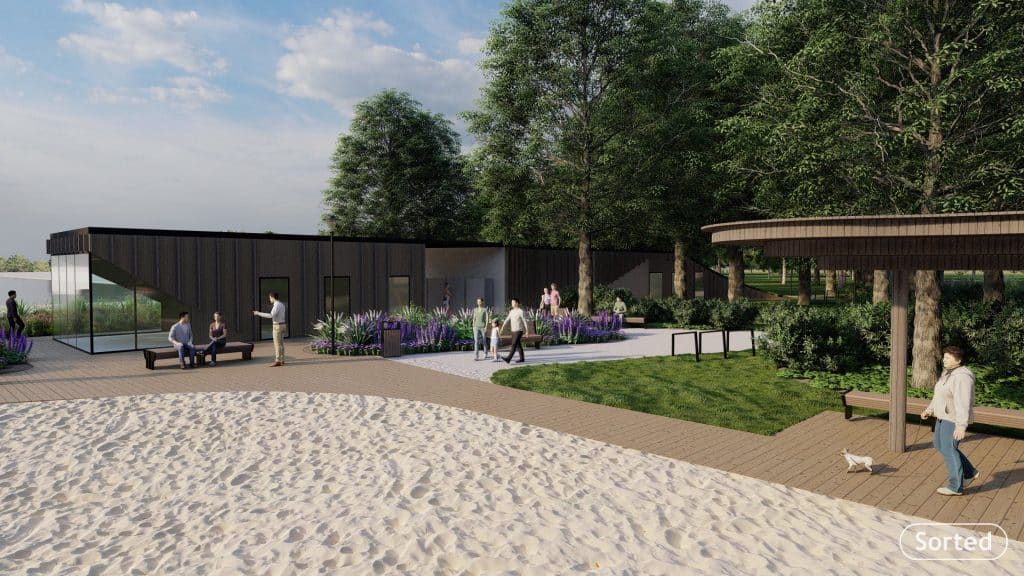 Nowoczesny obiekt rekreacyjny na plaży w Giżycku, otoczony zielenią i ścieżkami spacerowymi.