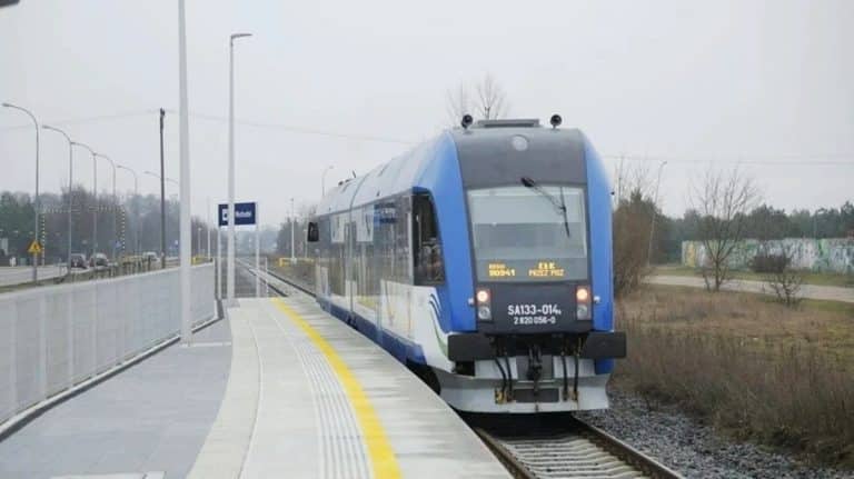 Nowoczesny pociąg elektryczny na nowo wybudowanej stacji kolejowej.