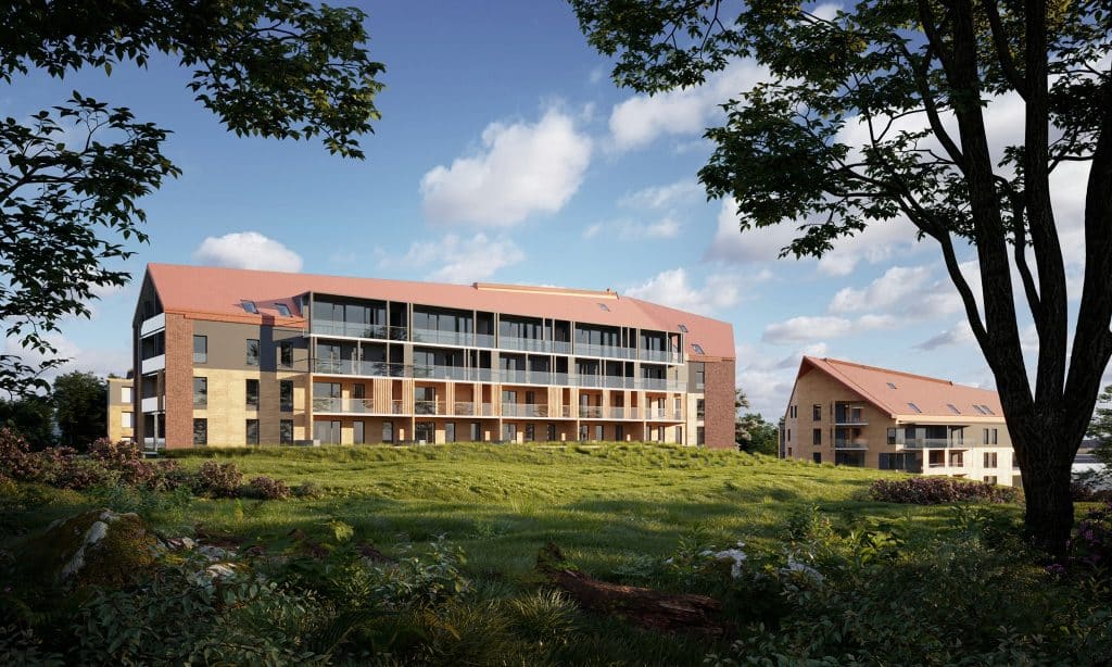 Nowoczesne apartamenty nad jeziorem na tle zielonego krajobrazu i nieba z chmurami.