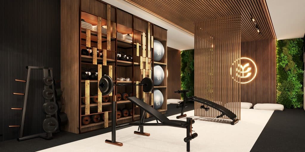 Nowoczesna siłownia z wyposażeniem i zielonymi elementami dekoracyjnymi.