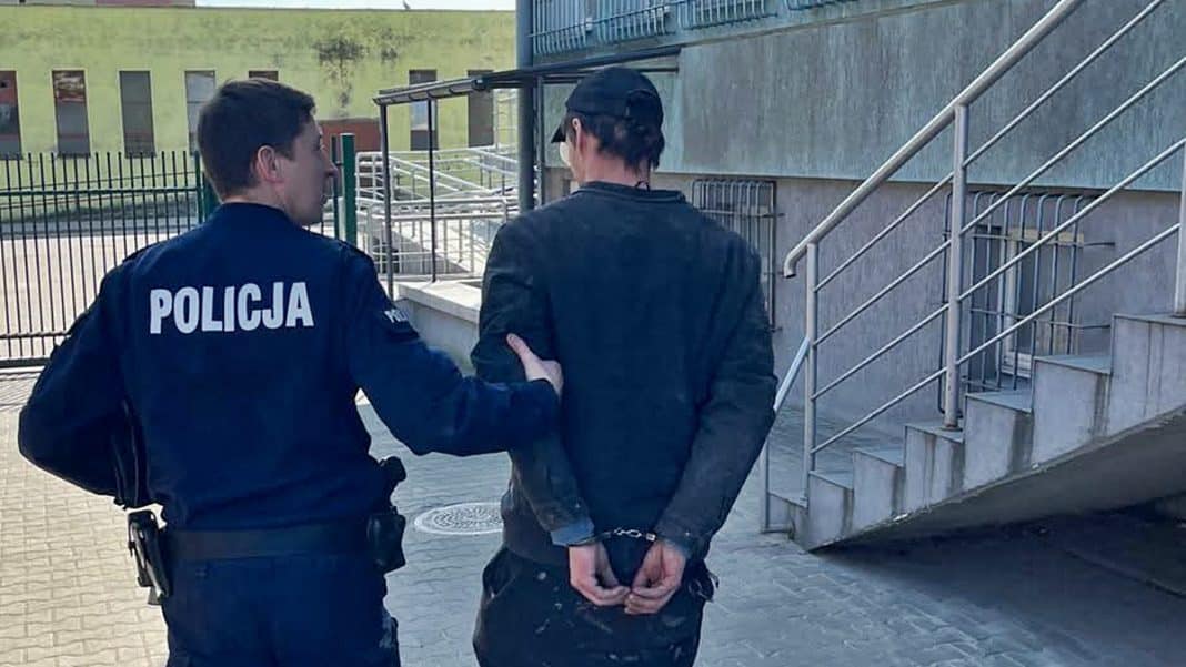 Policjant zatrzymuje poszukiwanego mężczyznę na ulicy w Olsztynie.