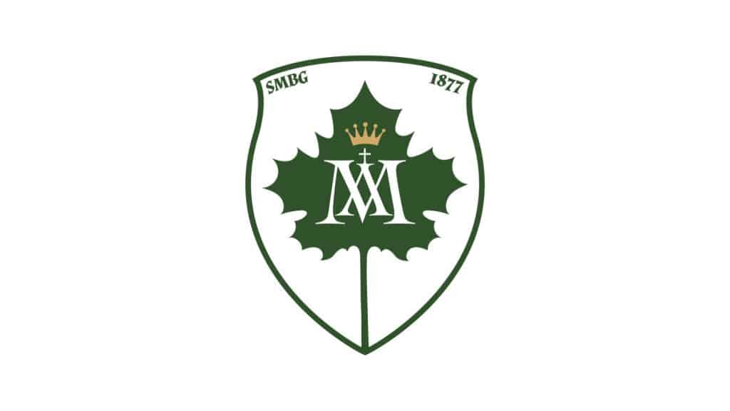 Herb sanktuarium z zielonym liściem, koroną i monogramem, otoczony napisem i datami.