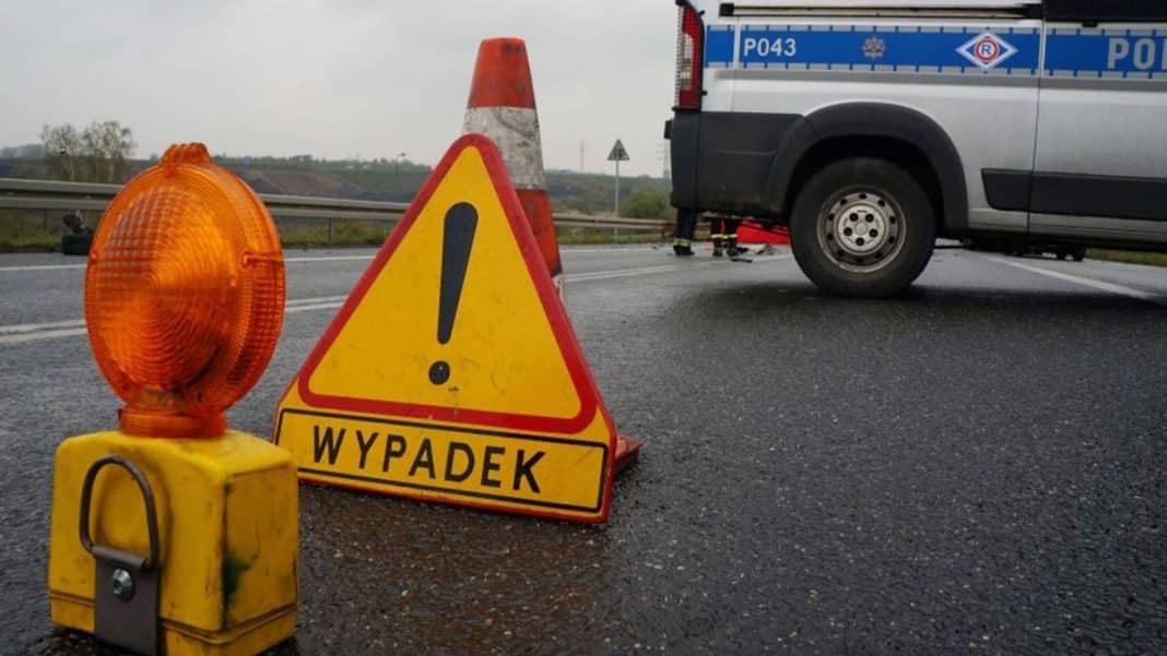 Zabezpieczenia na drodze serwisowej S51 po wypadku, widoczny samoch&oacute;d policyjny i oznakowanie.