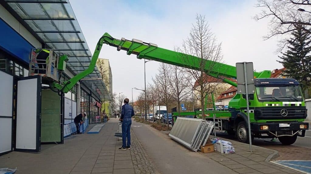 Prace na wysokości przy centrum handlowym w Olsztynie bez widocznych zabezpieczeń, interwencja służb.