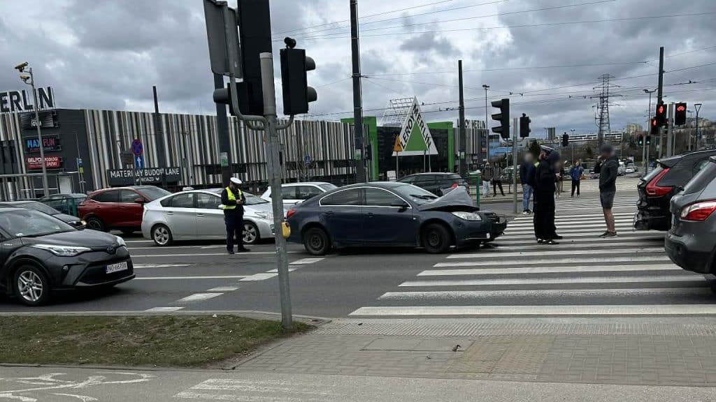 Kolizja dw&oacute;ch samochod&oacute;w na ruchliwym skrzyżowaniu w Olsztynie, policja na miejscu zdarzenia.