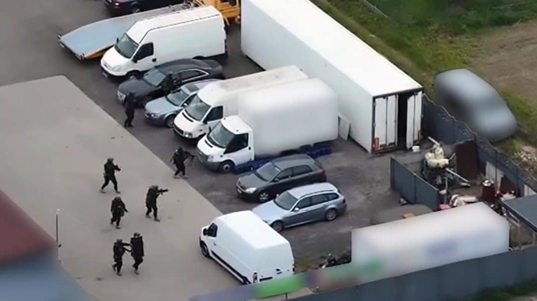 Akcja służb w miejscu zatrzymania, widoczne samochody i funkcjonariusze w akcji.