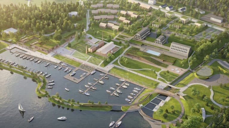 Widok z lotu ptaka na nowoczesny port nad jeziorem Guzianka Wielka z mariną i infrastrukturą rekreacyjną.