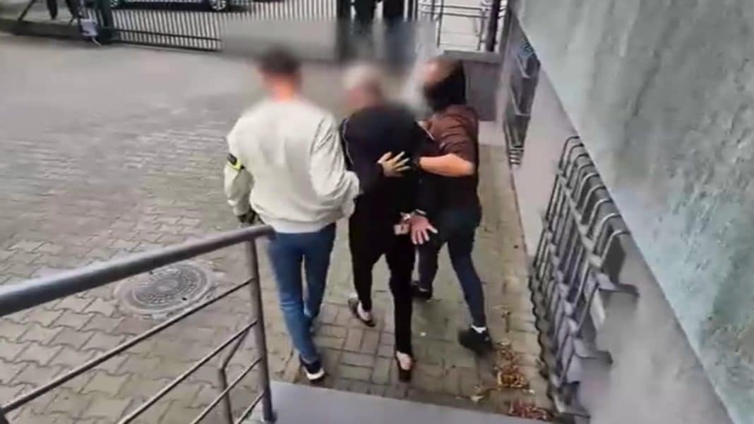Nagranie z zatrzymania podejrzanego w miejscu publicznym, trzy osoby trzymają mężczyznę.