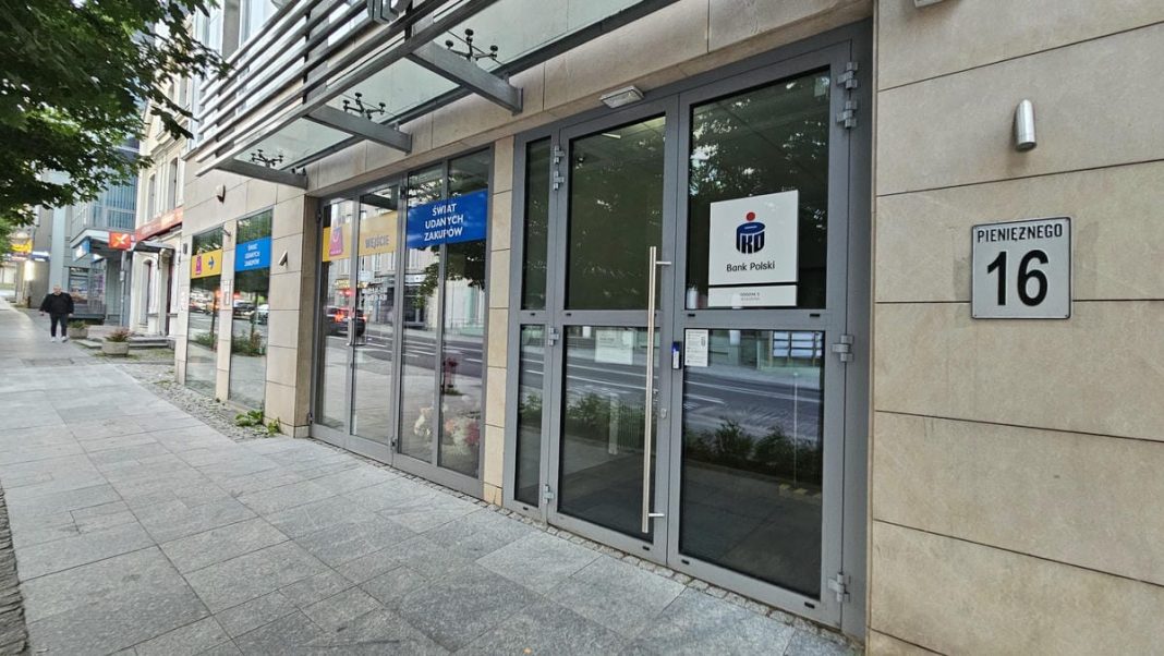 Wejście do banku PKO Bank Polski w centrum Olsztyna, na fasadzie widoczny logo banku.