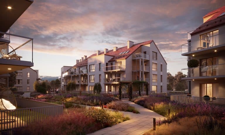 Nowoczesne apartamenty w otoczeniu zieleni i kwiatów, wieczorem z podświetlonymi balkonami i widokiem na zachód słońca.