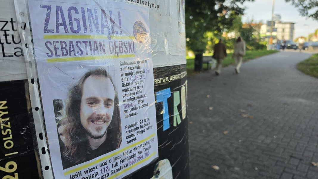 Plakat z informacją o zaginięciu 24-letniego Sebastiana Dębskiego przy ulicy, z jego zdjęciem i opisem.